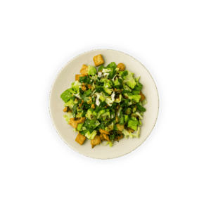 Ensalada César con lechuga, pollo, crotones, queso parmesano y aderezo.